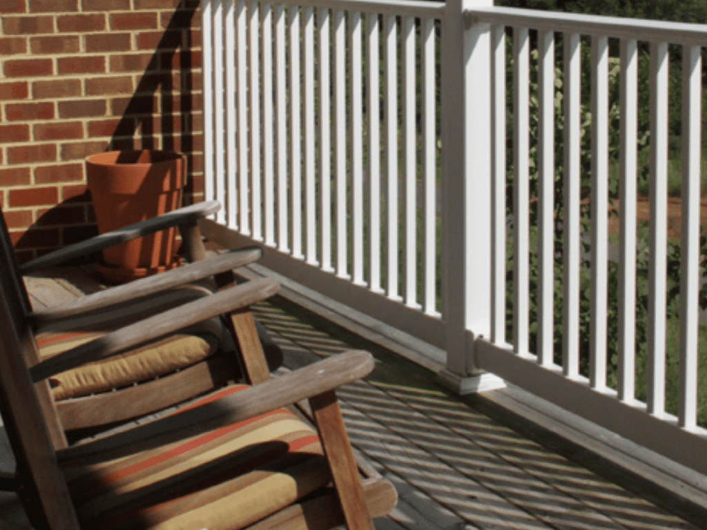 a rocking chair on a porch overlooking a mountain